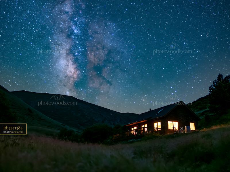 Modern house illuminated at night under Milky Way sky