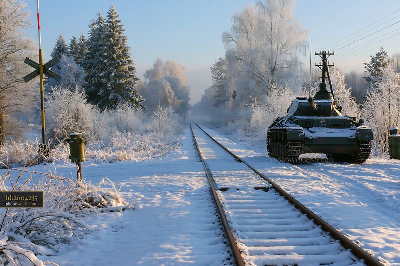 Panzer tank in winter snow near railway tracks in a frozen landscape