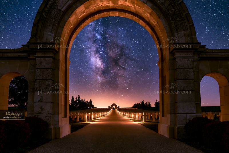 Soldiers' cemetery under a starry night with lit pathways