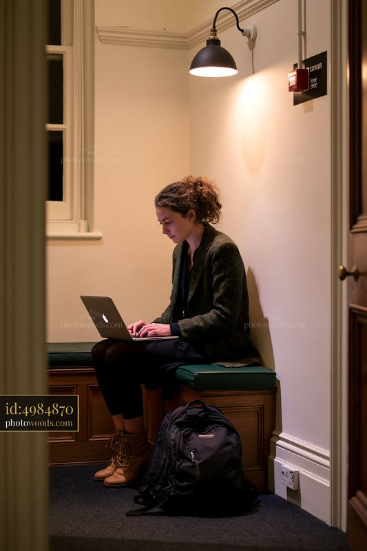 Employee attending online training in a quiet corner of a building