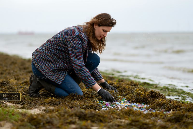 Coastline with plastic pollution cleanup in progress