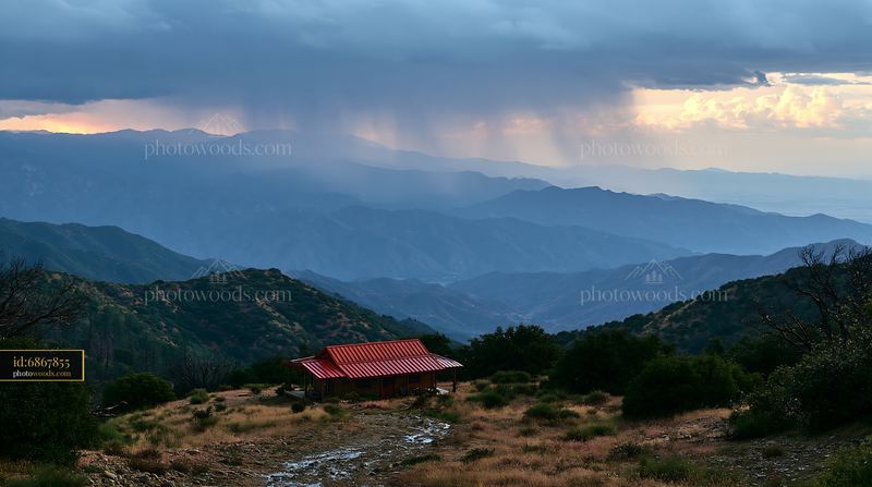 Thunderstorm over mountain range with a red-roofed building
