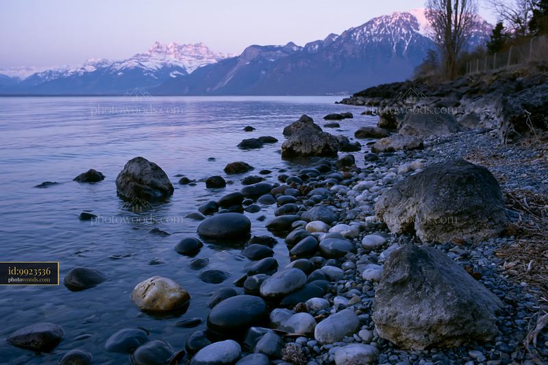 Swiss landscape with mountains and serene waters in golden light