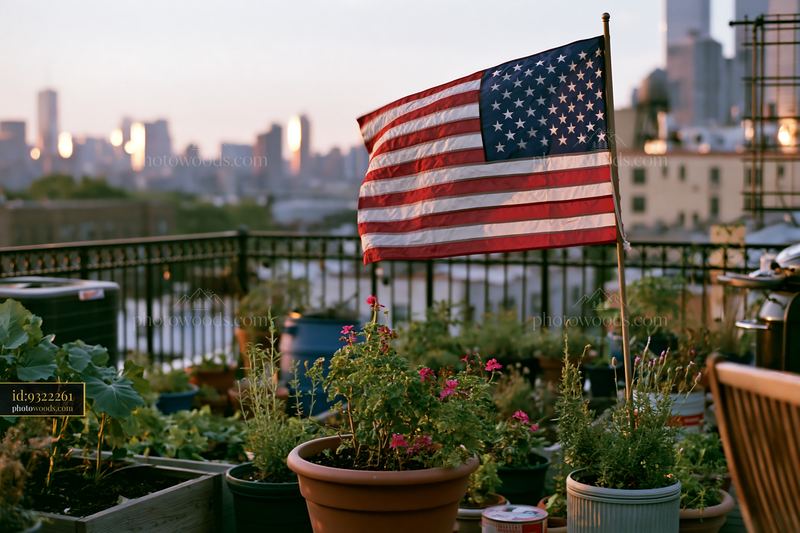 American flag flying in strong wind above urban rooftop garden