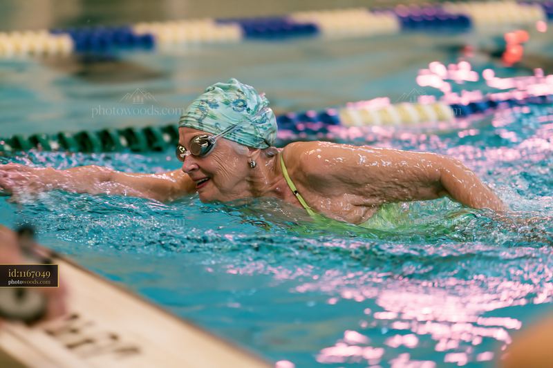 Senior woman swimming freestyle in lap pool