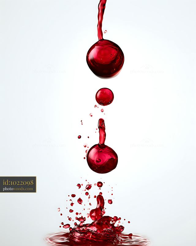 Red liquid drops falling into a pool of red liquid