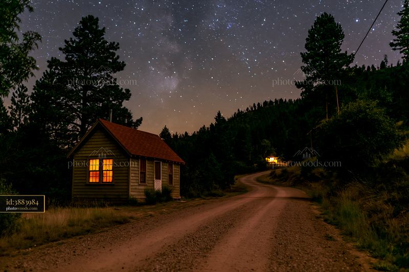 Home beneath stars and a dirt road at night