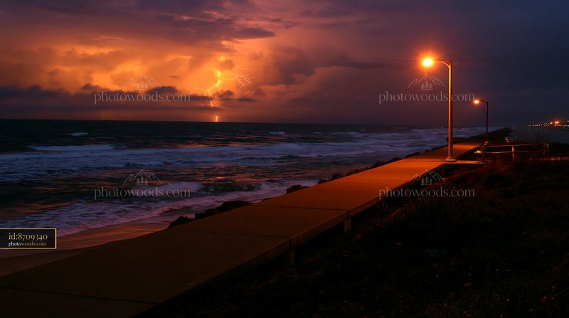Coastline with lightning over ocean during a stormy night
