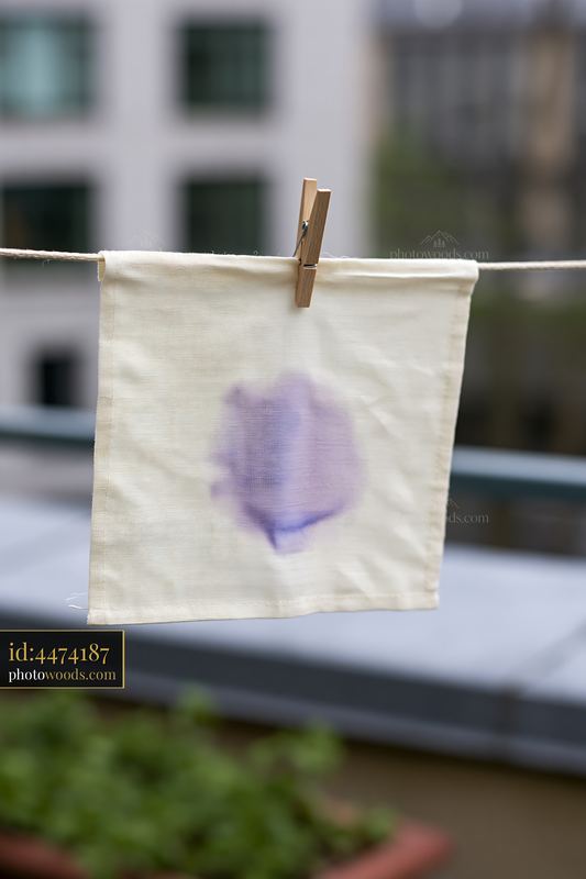 Watercolor stain on muslin fabric hanging on a clothesline
