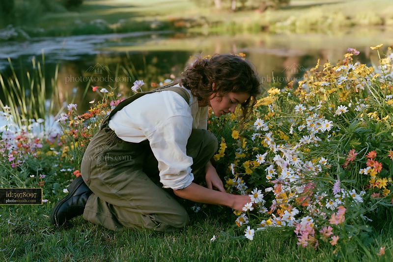 Meadow flowers beside a calm pond showing a woman picking blooms