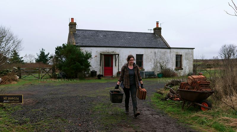 Country house renovation scene with woman carrying materials