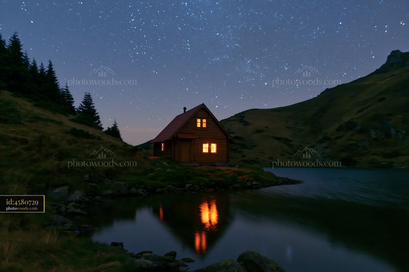 Isolated cabin beneath a starry sky with reflection in water
