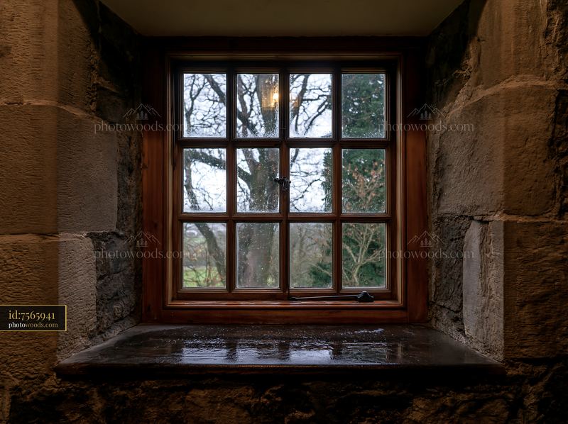 Wet wooden casement window on a cloudy day