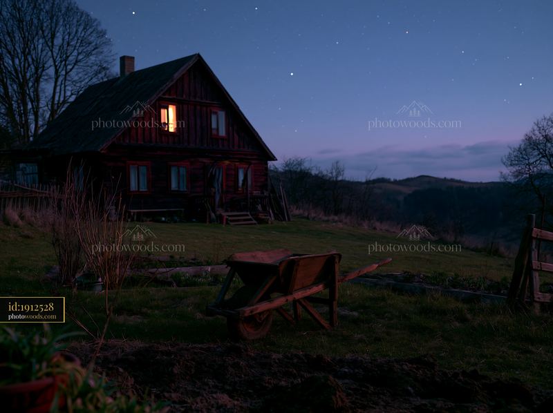 Farmhouse beneath stars and rolling hills at night