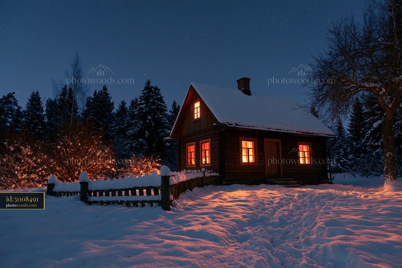 Snowy house under stars with warm glow from windows