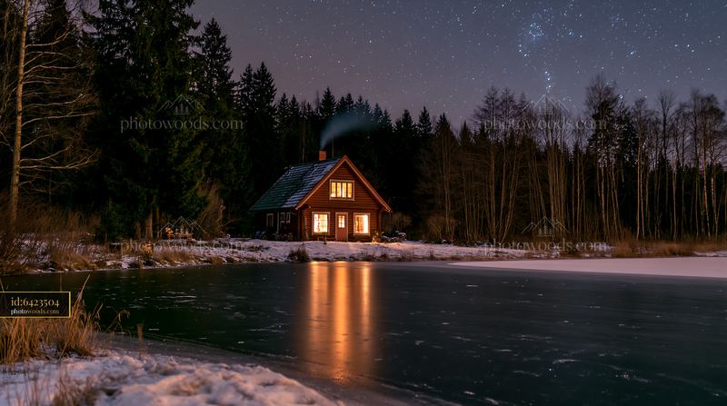 House with chimney smoke under stars near frozen pond
