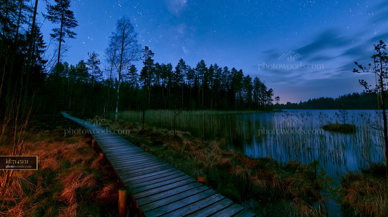 Photographing star trails over a lake at night