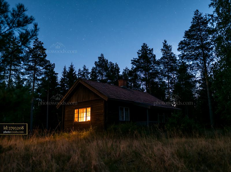 Villa beneath a star-filled sky with glowing windows at night