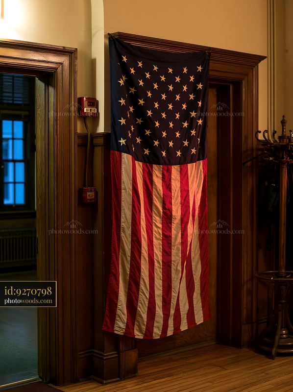 American flag hanging vertically in indoor setting