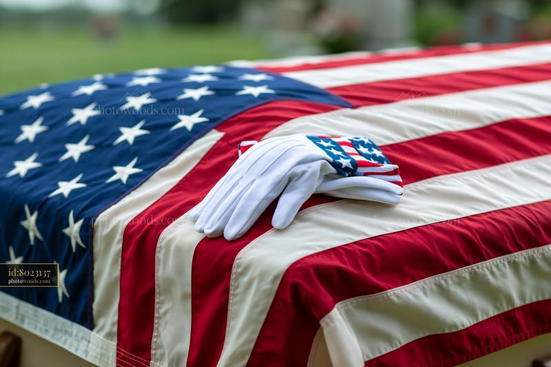 American flag draped over casket in outdoor setting