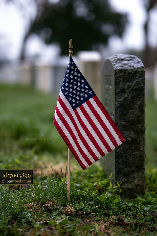 American flag placed near gravestone at Arlington cemetery
