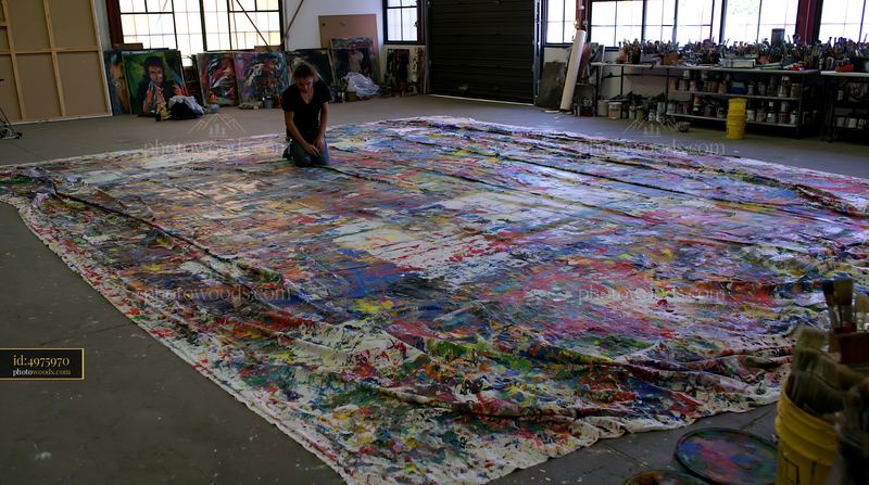 Large splattered artist canvas in a creative workspace