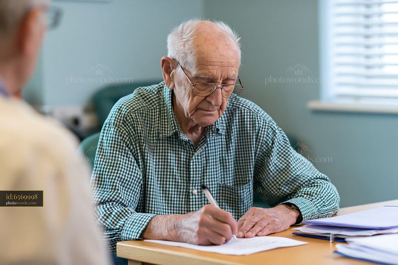 Elderly patient with tremor examined during doctor visit