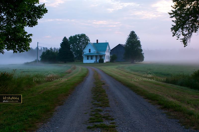 Old farmhouse with barn on a misty morning