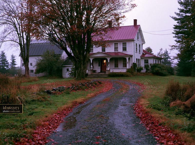 Charming old farmhouse with barn surrounded by autumn leaves