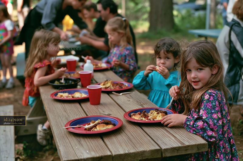 Charity event buffet with children enjoying food outdoors