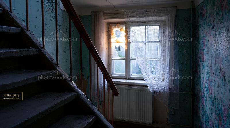 Decaying Stairwell With Window in Abandoned Apartment Block