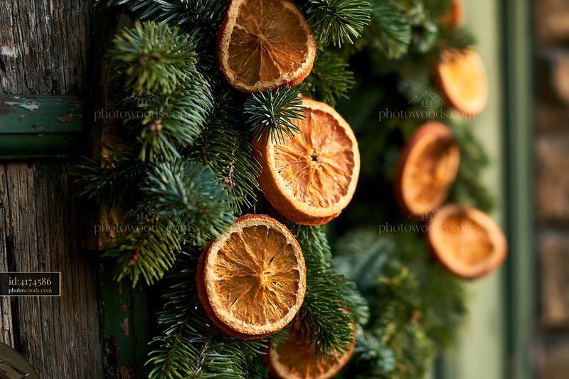 Christmas wreath with dried orange slices on a rustic door