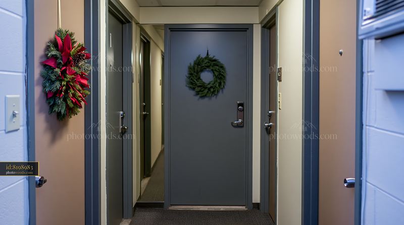 Christmas wreath on an apartment door in a hallway
