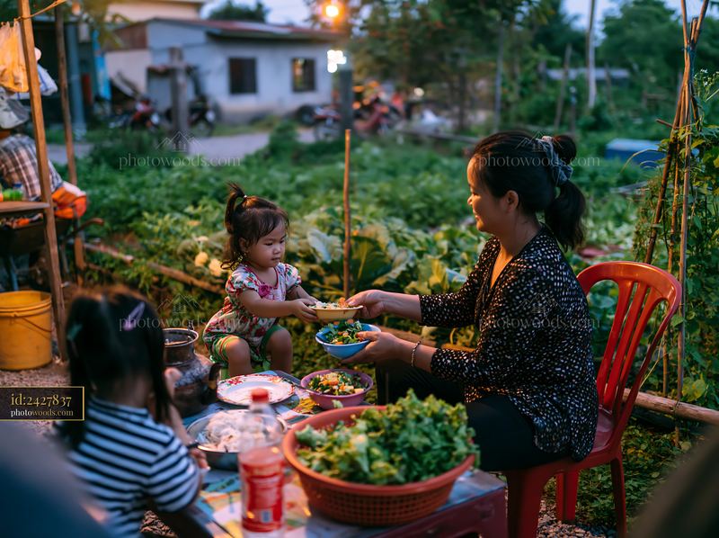 Family sharing food at an outdoor food stall