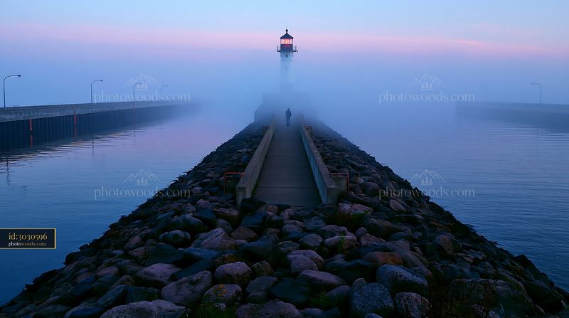 Foggy lighthouse pier at twilight