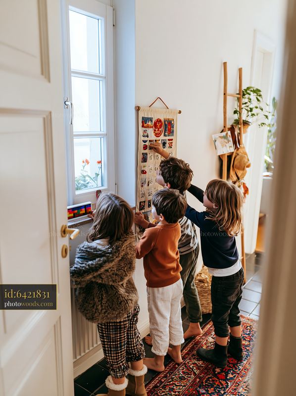 Four children opening a fabric advent calendar at home