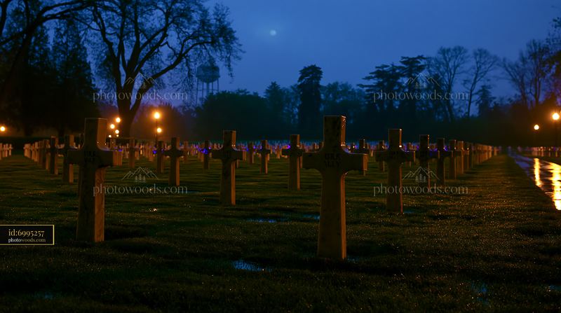 Soldier graves under a deep blue night sky with lights