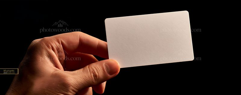 Hand Holding a Blank Credit Card in Dark Setting