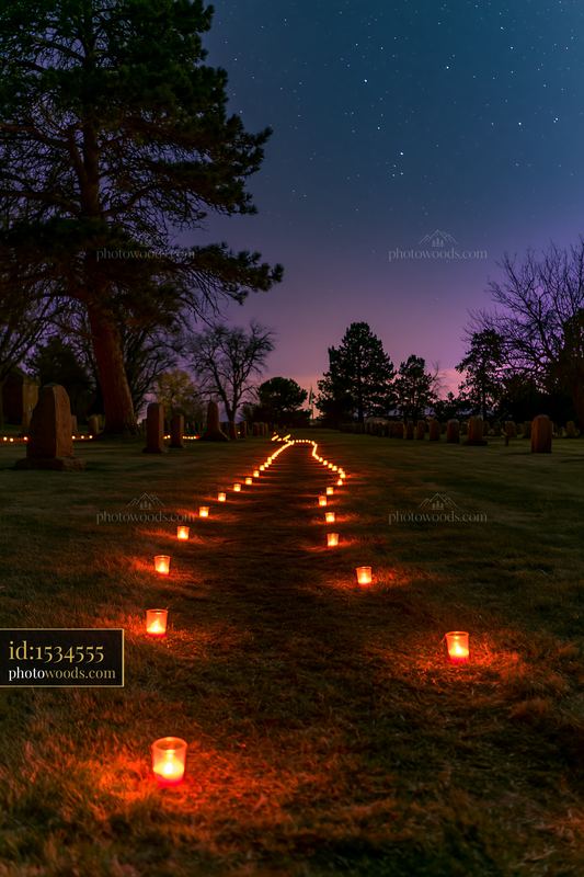 Memorial candles lining military graves under stars
