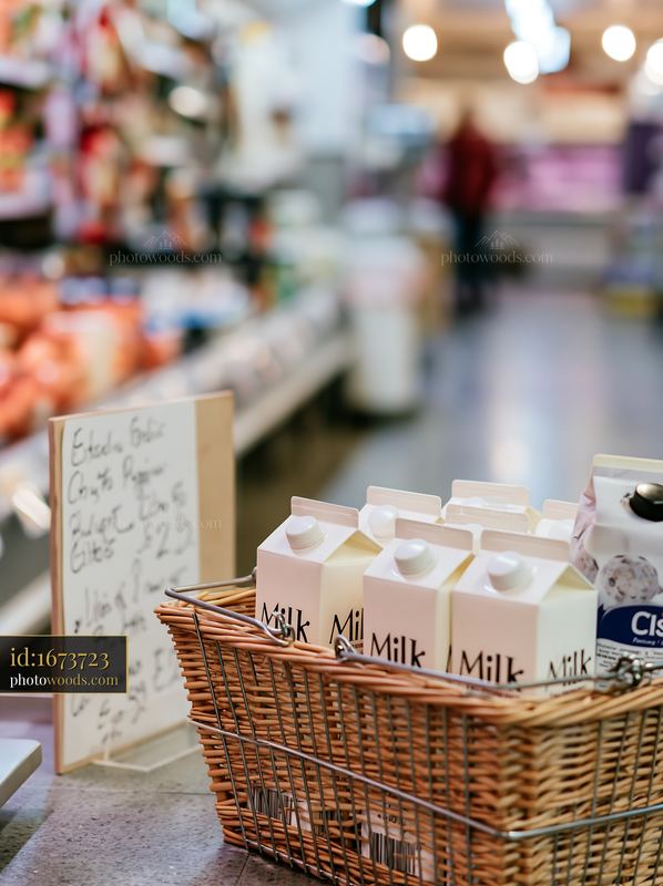 Milk cartons in a shopping basket at a market