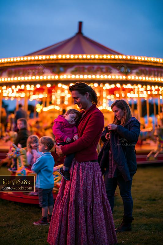 Family at a Fairground Carousel at Dusk