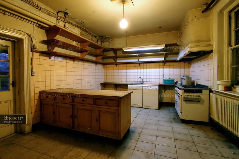 Old Kitchen With Cluttered Shelves and Empty Countertops