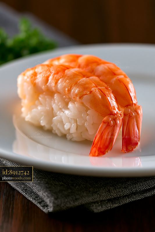 Shrimp sushi piece served on white plate