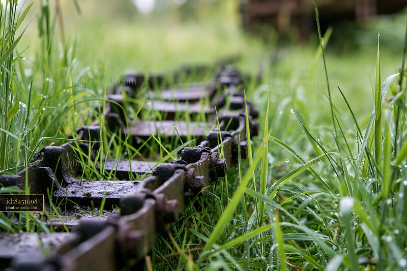 Panzer tank tracks close-up covered in grass and dirt