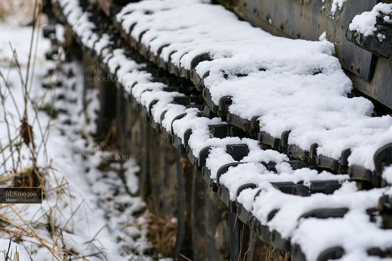 Close-up view of panzer tank tracks covered in snow