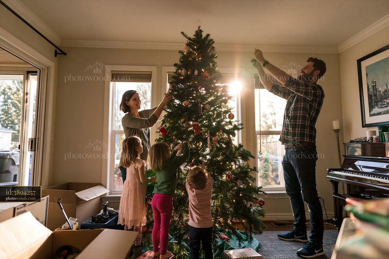 Family decorating a Christmas tree together