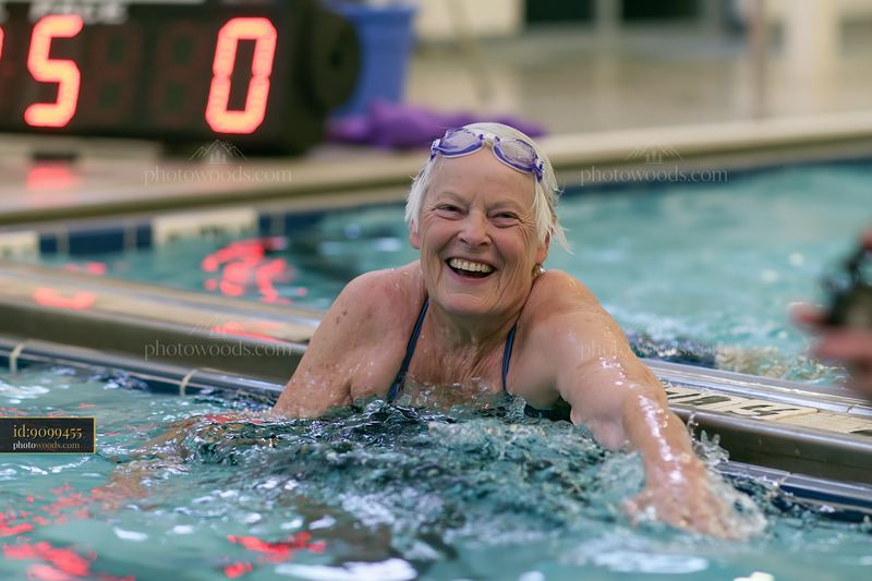 Senior woman swimming in an indoor lap pool