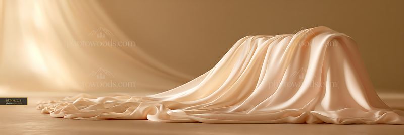 Soft silk draped across a smooth surface in warm light
