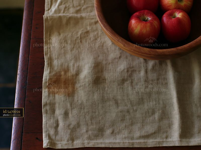 Stained handmade linen table runner with apples in wooden bowl