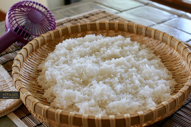 Sushi rice cooling on tray in a kitchen setting